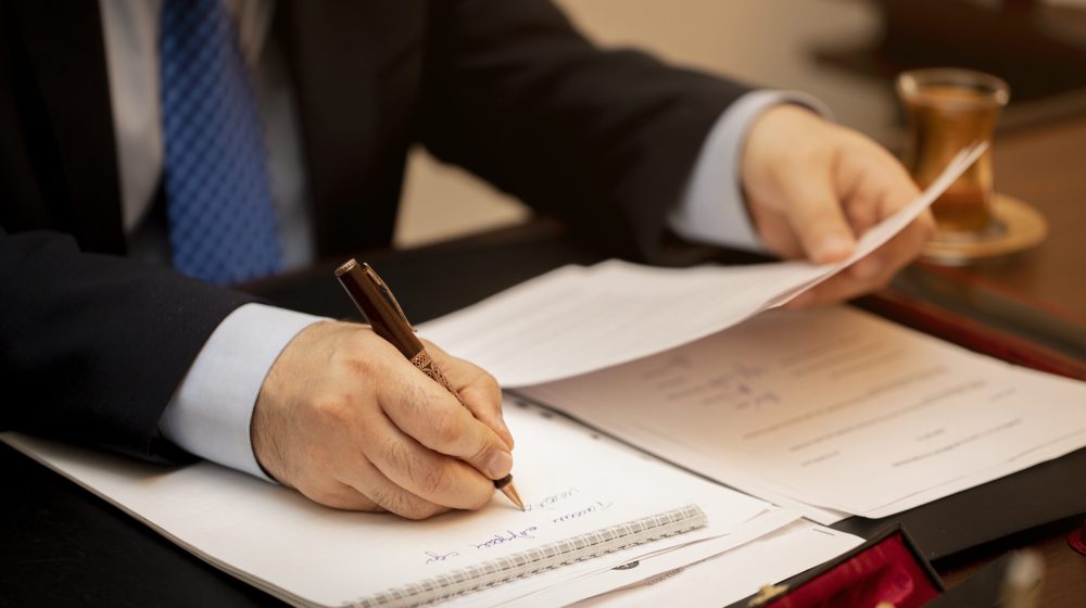 Businessman signing important contract papers. High quality photo